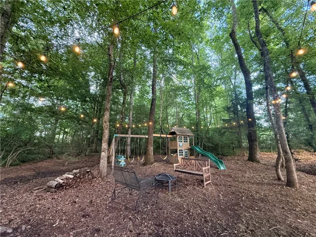 This tranquil wooded yard offers a private retreat with ample space for outdoor enjoyment.