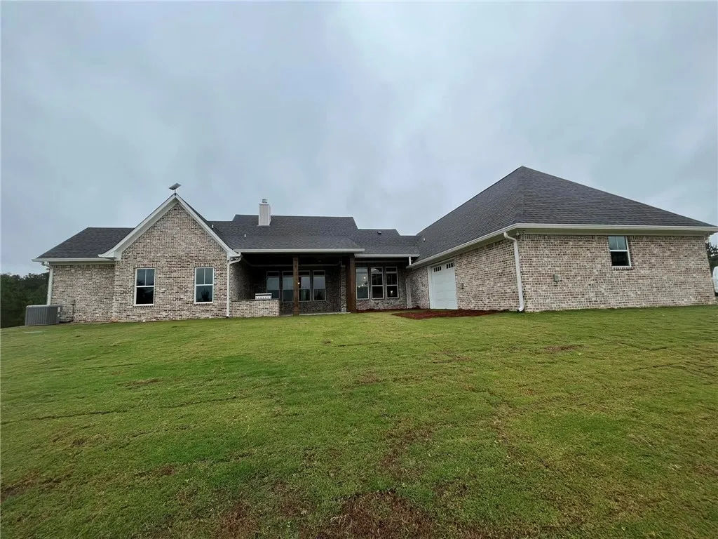 *EXAMPLE OF FINISHED PRODUCT* This spacious property features a charming brick exterior and an expansive green yard.