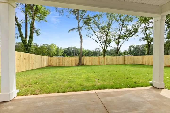 A spacious, enclosed backyard with a freshly cut lawn awaits outdoor enjoyment.
