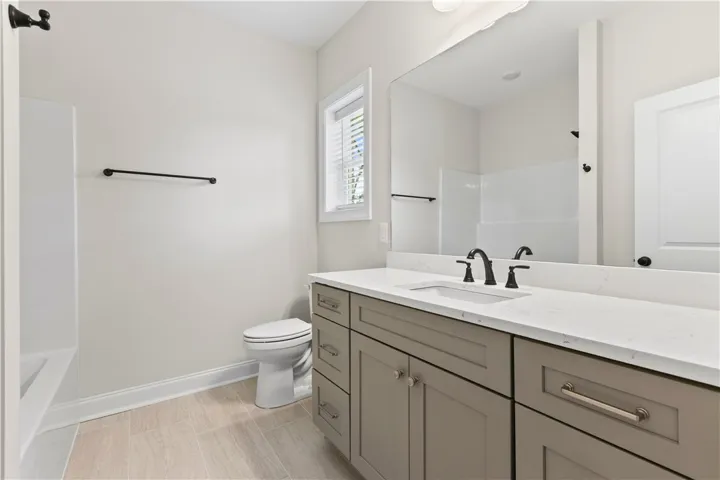 A well-appointed bathroom features a modern vanity and ample counter space.