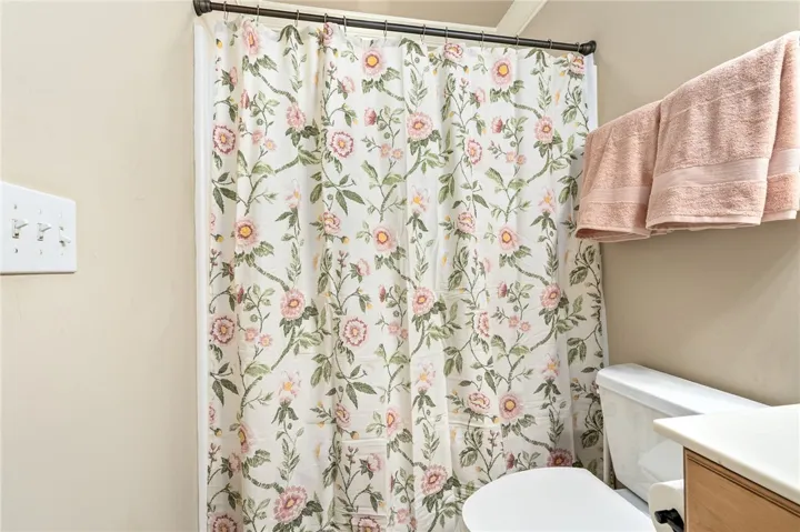 This bathroom provides practical amenities and a clean, refreshing atmosphere.