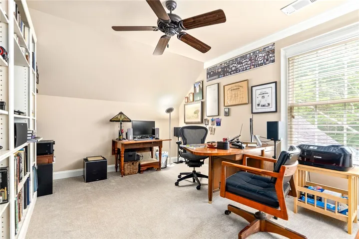 This dedicated workspace features ample natural light and a comfortable setting for productivity.