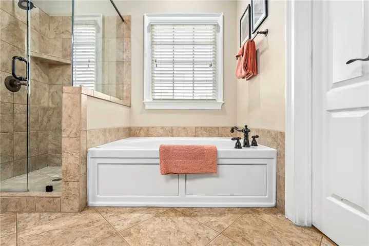 This bathroom offers both a shower and a soaking tub for ultimate relaxation.