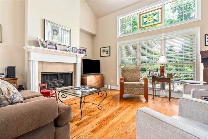 This inviting living area boasts rich hardwood floors and a cozy fireplace, perfect for gatherings.