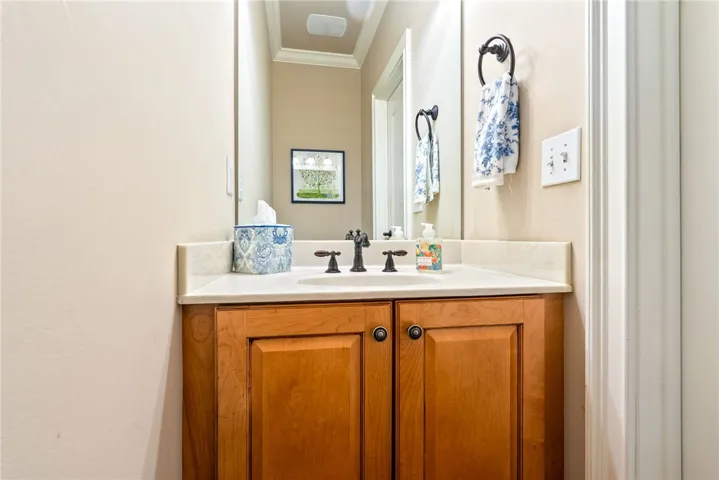 This powder room features a classic vanity with a pristine countertop and elegant fixtures.