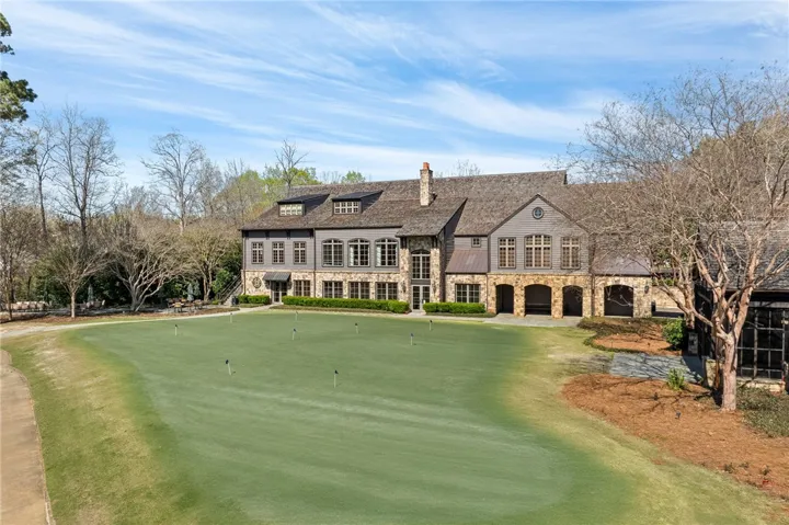 This magnificent residence boasts exceptional craftsmanship and a prime location next to a lush putting green.