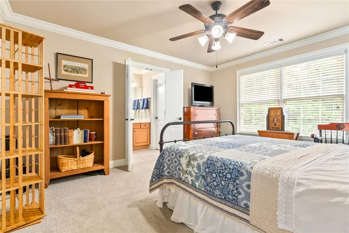 This cozy bedroom features comfortable flooring and ample natural light, creating a peaceful retreat.