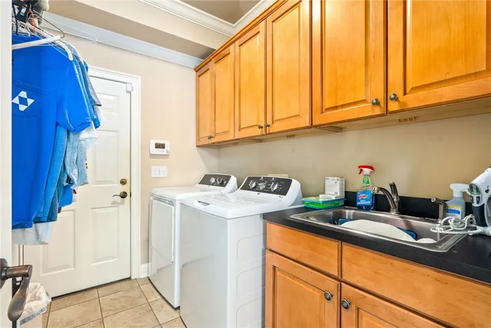 This functional laundry room features ample storage and modern conveniences for everyday living.