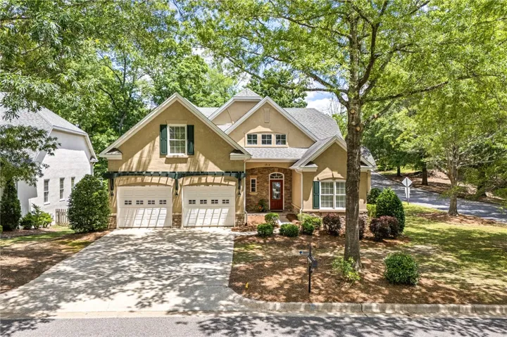 This beautiful stucco home features an attached garage and a concrete driveway, blending comfort with curb appeal.