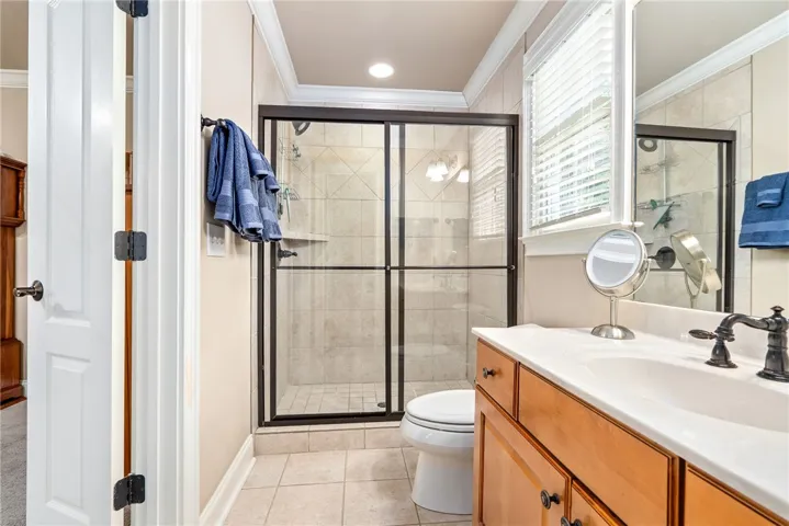 This bright bathroom features a spacious shower and ample counter space for daily routines.