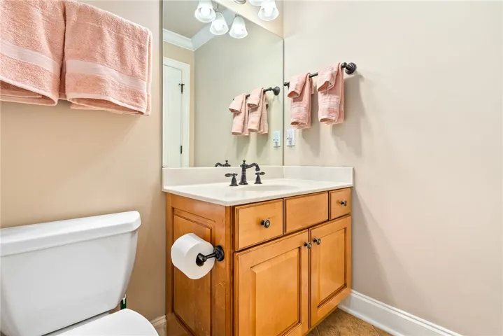This bathroom features a sleek vanity and convenient toilet, offering both style and functionality.