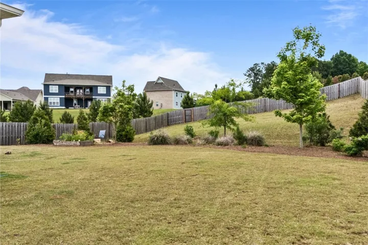 This spacious yard offers a tranquil outdoor retreat, perfect for relaxation and recreation.