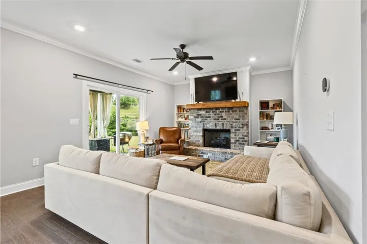 This inviting living space features a cozy fireplace and convenient access to the outdoors.