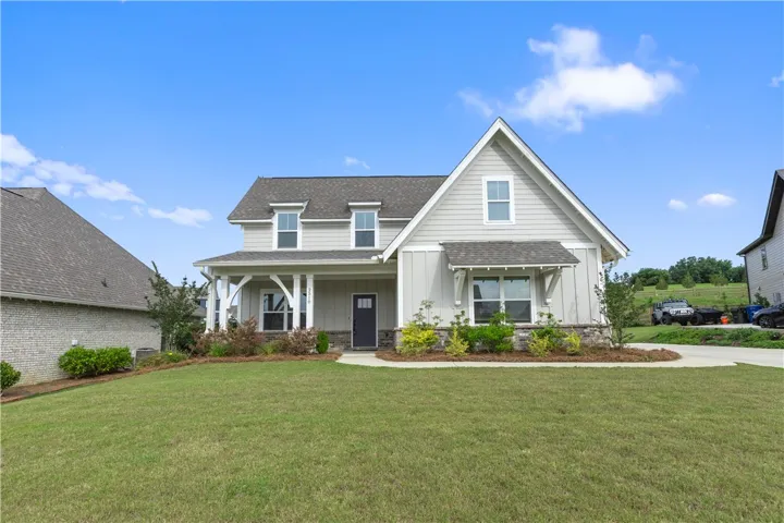 This charming home offers a welcoming facade with a well-maintained lawn, perfect for outdoor enjoyment.