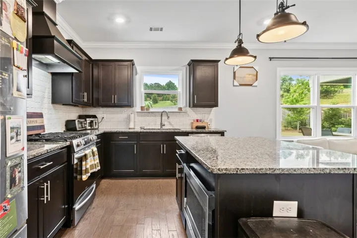 This spacious kitchen offers a blend of style and functionality, perfect for culinary endeavors and gatherings.