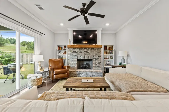 This living room features a fireplace and offers convenient outdoor access.