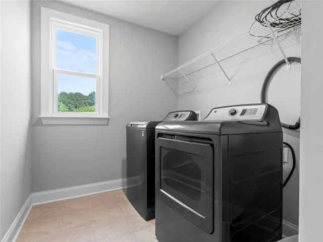This dedicated laundry room provides convenience and a bright atmosphere.
