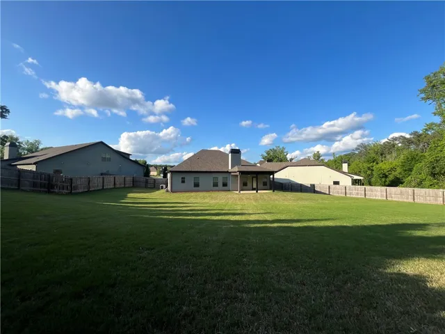 This residence features a private yard, covered patio, and fenced perimeter, perfect for outdoor enjoyment.