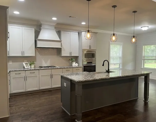 This newly designed kitchen features an expansive island and premium stainless steel appliances.