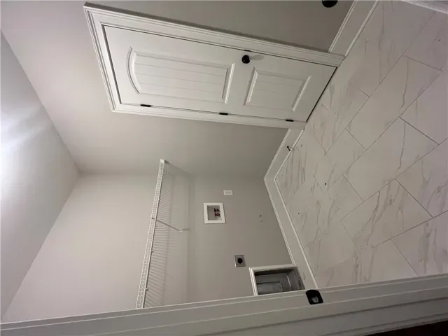 This laundry room features durable tile flooring, providing a practical and clean space for household tasks.