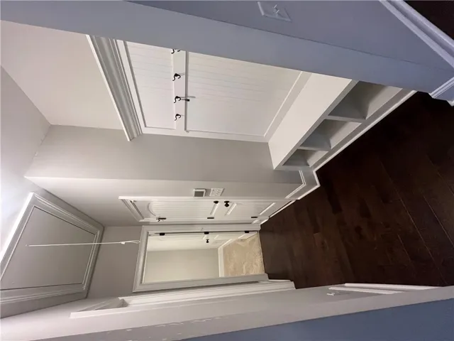 This organized mudroom features practical built-in storage and sleek wood flooring.