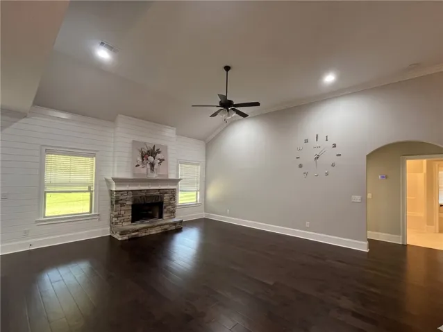 An inviting great room featuring a cozy fireplace and vaulted ceilings.
