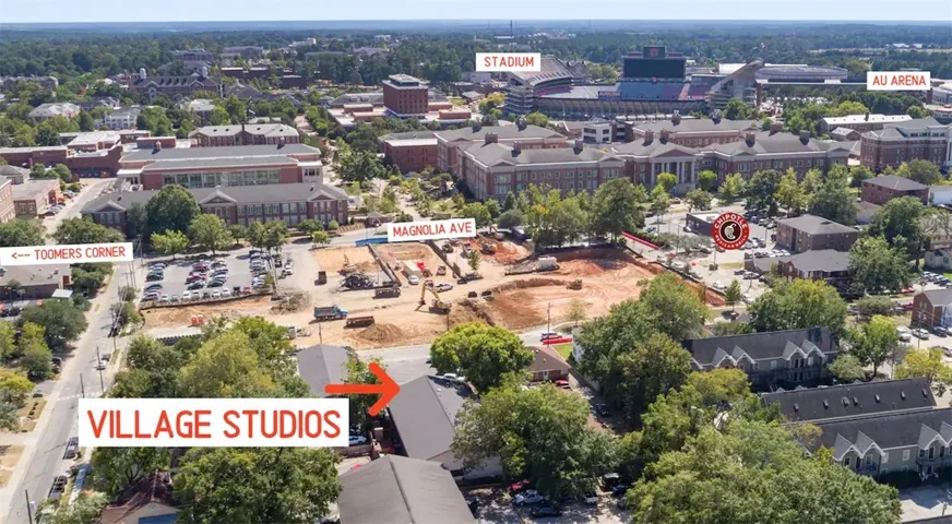This bird's-eye view captures a vibrant neighborhood, showcasing residential areas and institutional buildings under development.