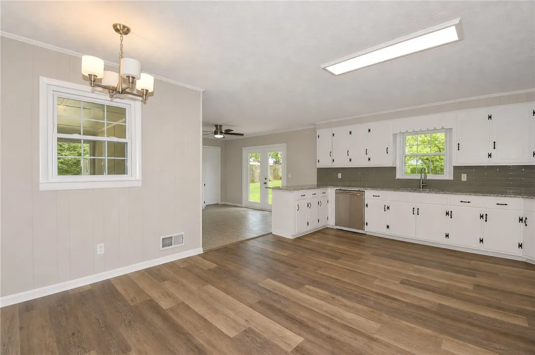 This bright kitchen features new flooring and convenient outdoor access, perfect for entertaining.