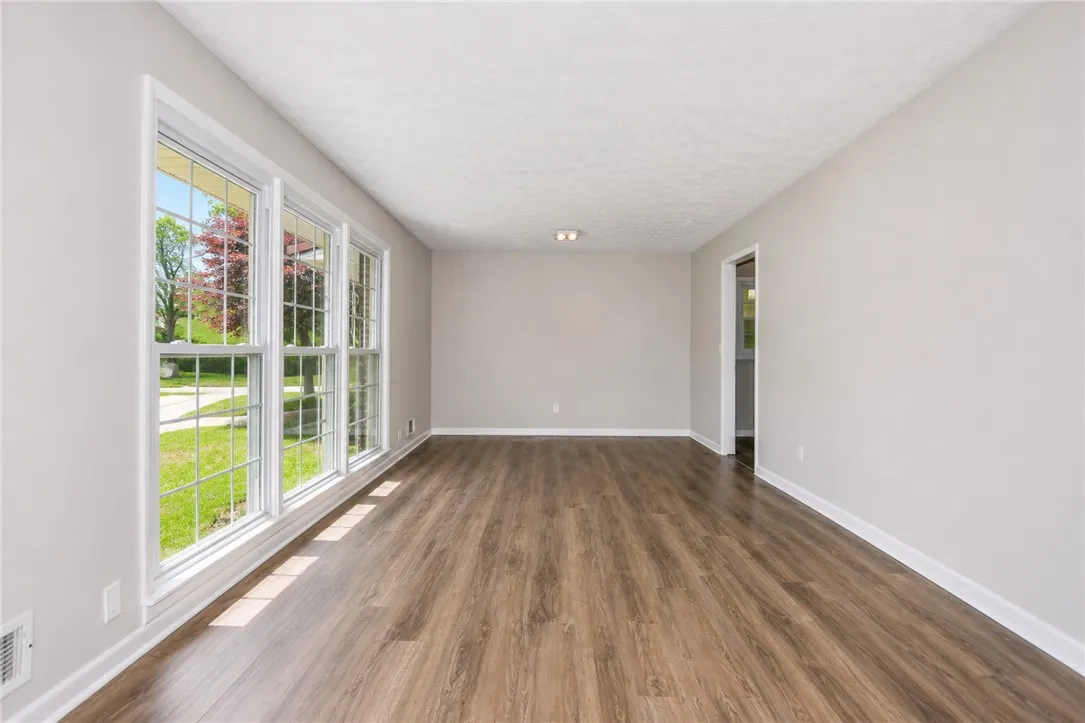 This bright, airy room features expansive windows, creating an inviting atmosphere.