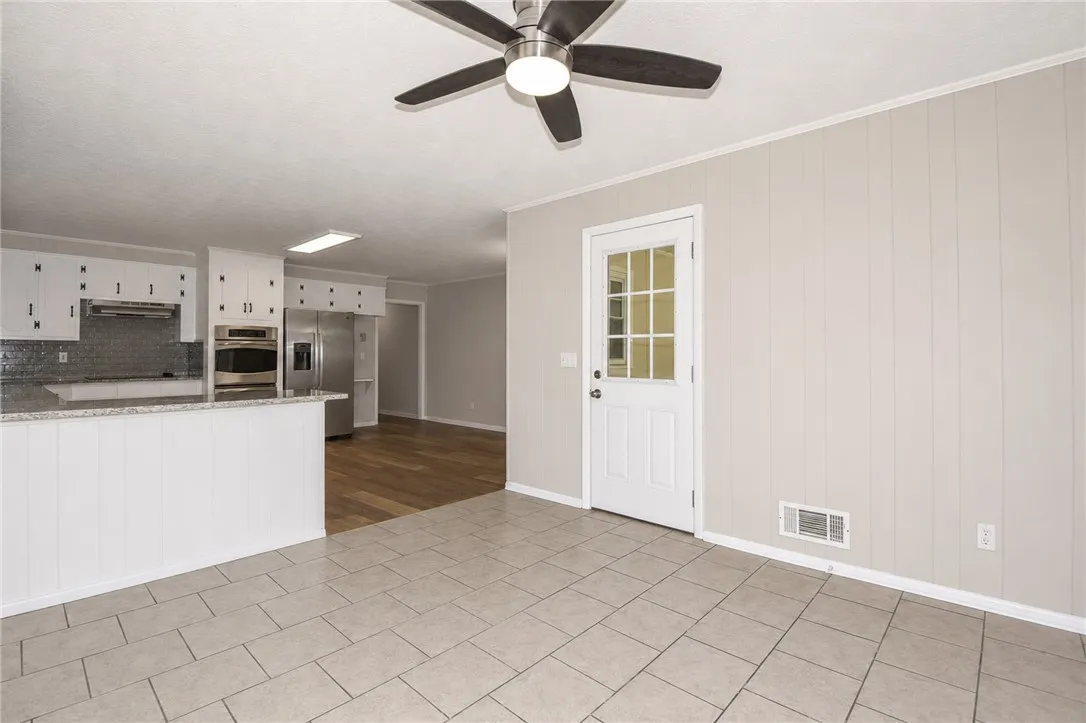 This bright kitchen and dining area features contemporary finishes and durable flooring.