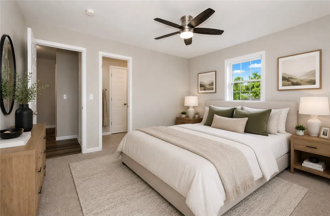 This tranquil bedroom offers comfort and natural light for restful living.