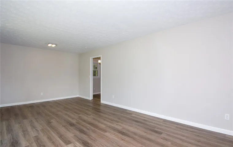 This bright, spacious interior features durable flooring and a neutral palette, offering a versatile living space.