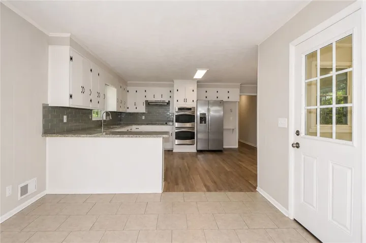 This bright kitchen features modern appliances and a seamless flow into adjacent spaces.