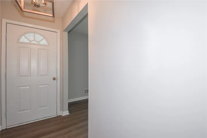 Enter into a welcoming interior featuring durable flooring and an inviting ambiance.