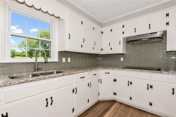 This bright kitchen features ample counter space, modern appliances, and a lovely view.