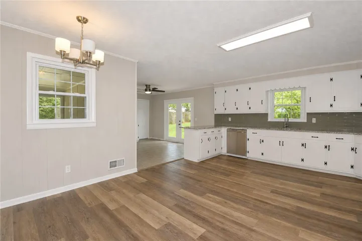 This bright kitchen features new flooring and convenient outdoor access, perfect for entertaining.