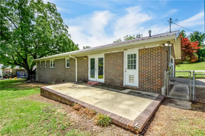 This residence features a brick exterior and a spacious patio for outdoor enjoyment.