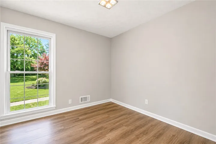 Bright room with natural light and durable flooring, offering a versatile space for living.