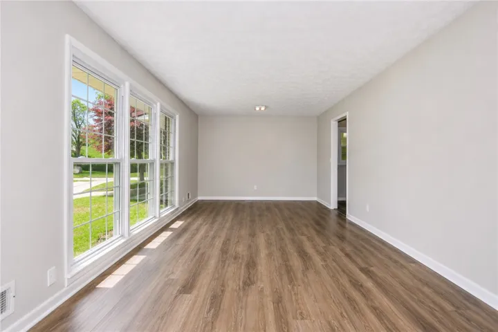 This bright, airy room features expansive windows, creating an inviting atmosphere.