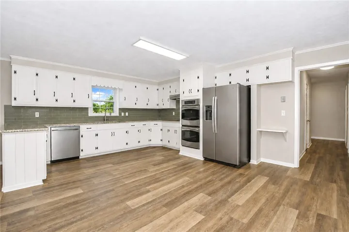 This spacious kitchen offers a functional layout with ample cabinet space.