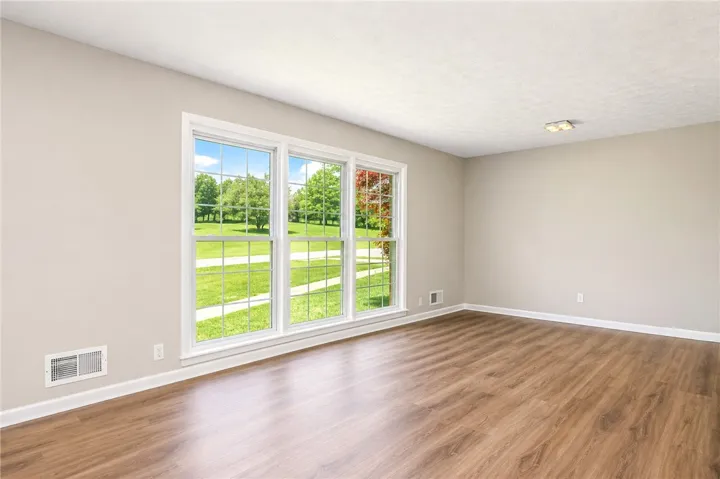 This bright space features ample natural light and durable flooring, offering a versatile living area.