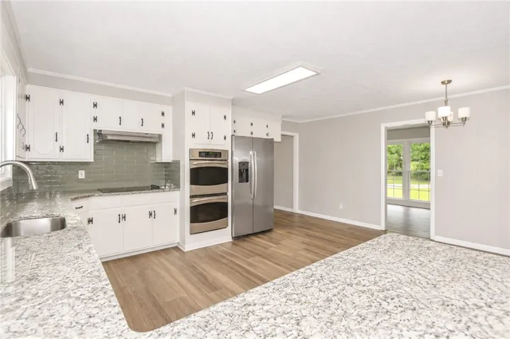 Bright and inviting kitchen with ample counter space, perfect for culinary endeavors and casual dining.
