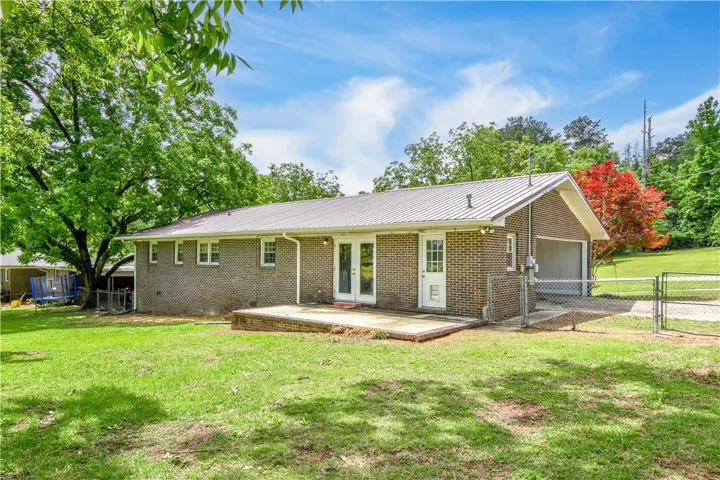 This property features a spacious backyard with a patio, perfect for outdoor enjoyment.