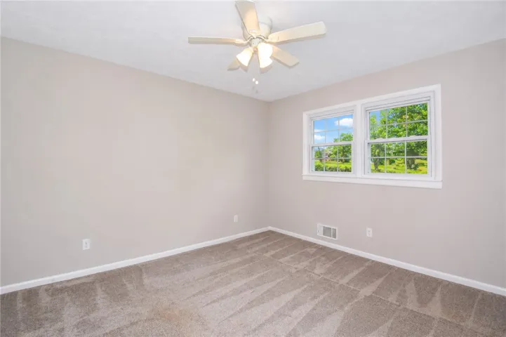 This cozy room offers natural light and comfortable carpet, ready for personalization.