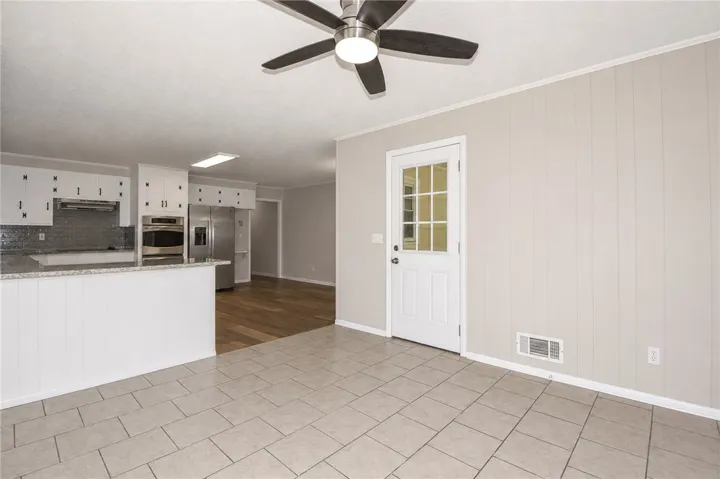 This bright kitchen and dining area features contemporary finishes and durable flooring.