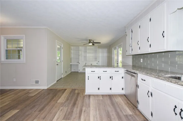 This spacious kitchen and living area features modern amenities and abundant natural light.