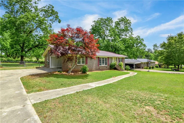 This charming brick home features a spacious yard and inviting curb appeal.
