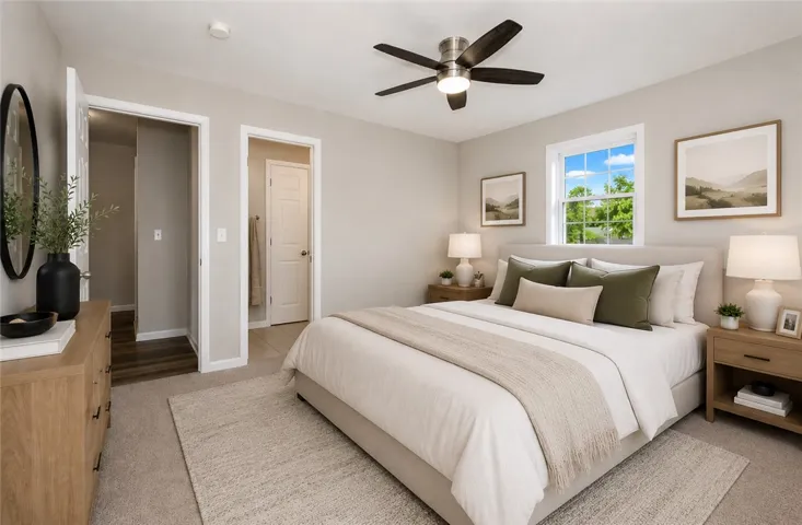 This tranquil bedroom offers comfort and natural light for restful living.