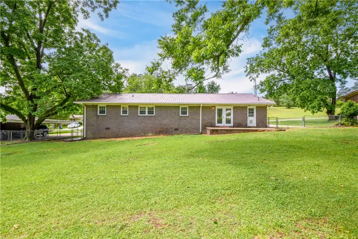 This residence features a large backyard, perfect for outdoor activities and serene living.