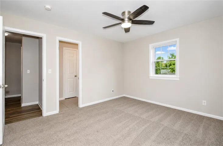 Bright and airy room with serene views of lush greenery through a charming window.